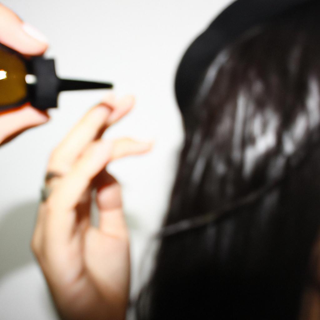 Person applying oil to hair