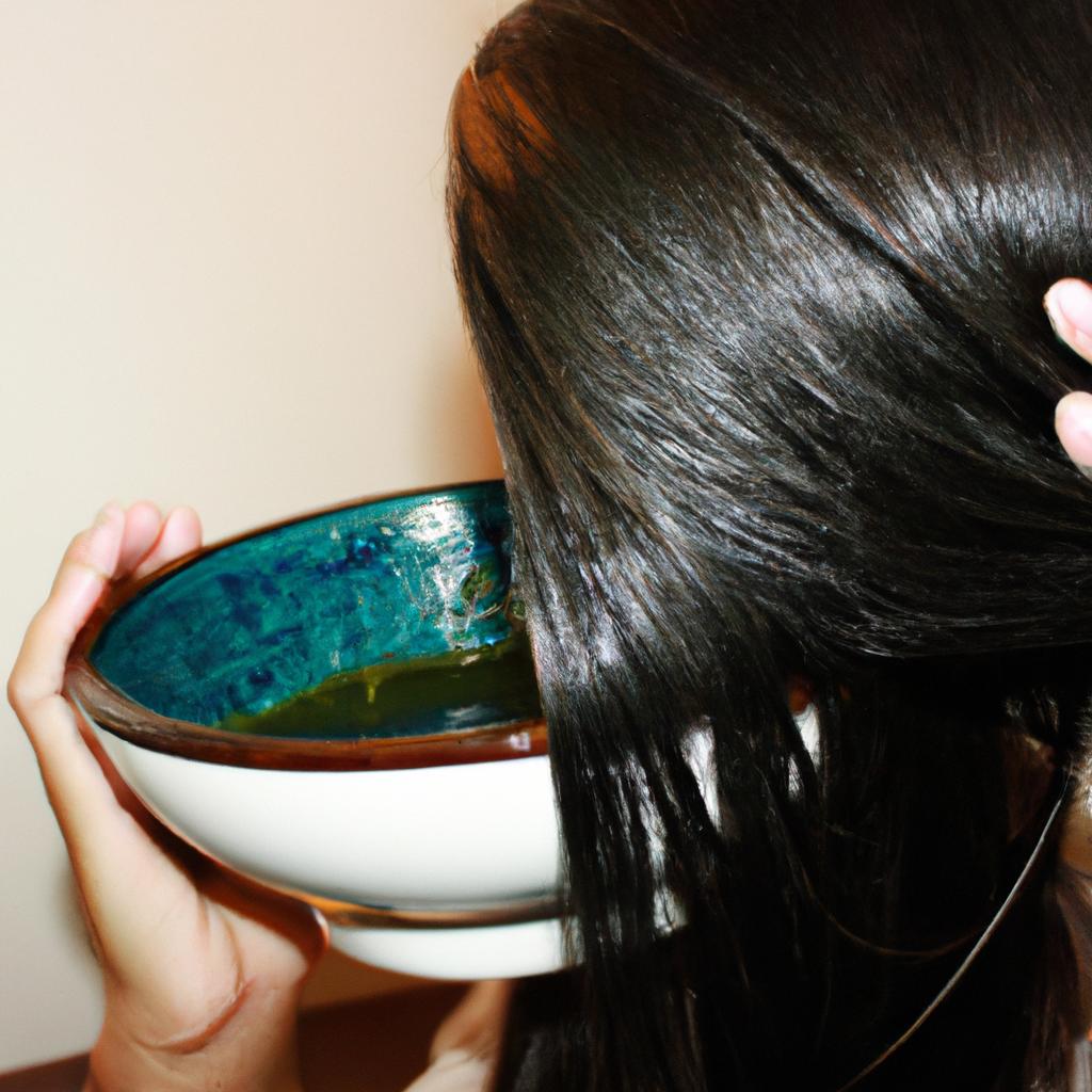 Person applying herbal hair mask